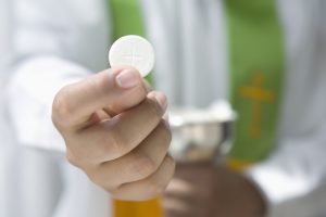 Priest Holding Communion