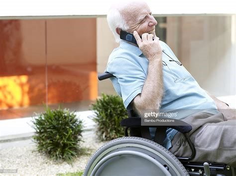 Homebound Friends Man on a Wheelchair talking on his phone with volunteer.